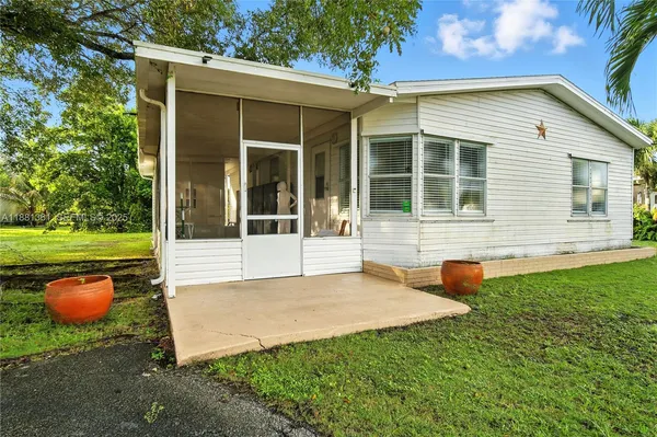 a view of a house with backyard porch and sitting area