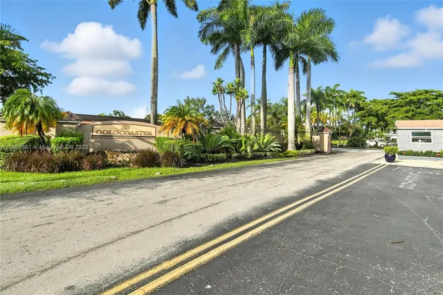 a view of a street with palm trees