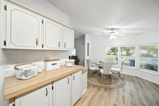 a view of a kitchen and dining room with wooden floor