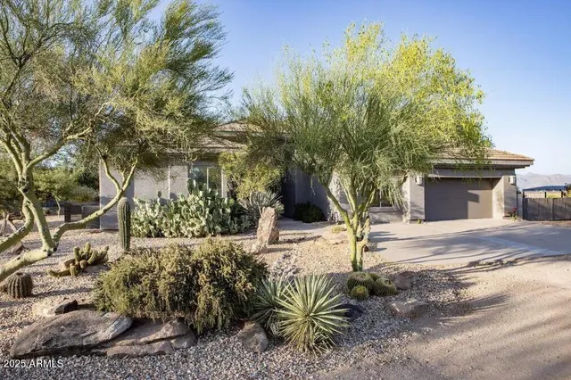 a view of a house with a yard and sitting area