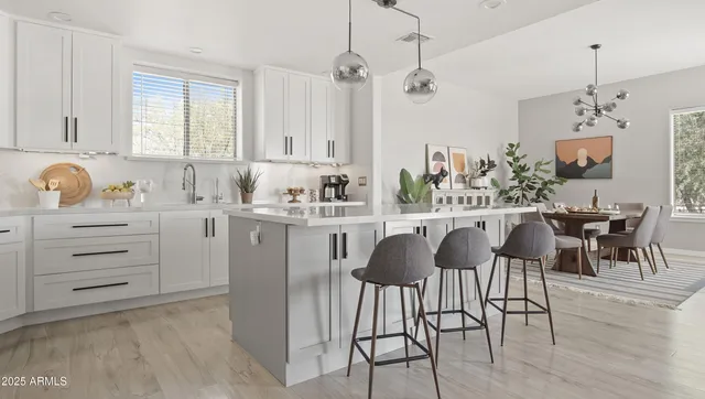 a kitchen with stainless steel appliances granite countertop a sink a stove and a refrigerator