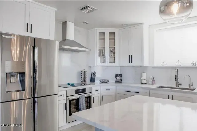 a view of a dining room with furniture and a chandelier