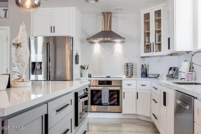a bedroom with two beds and a flat screen tv