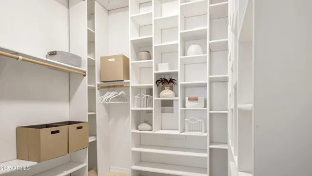 a living room with furniture a fireplace and a large window