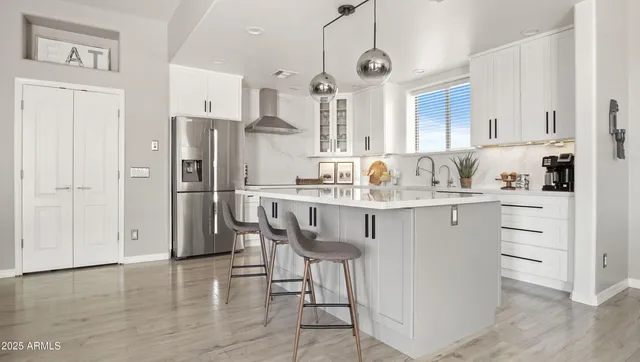 a kitchen with refrigerator cabinets and wooden floor