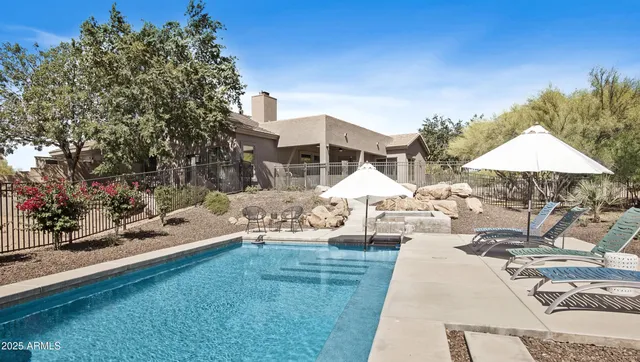 an aerial view of a house with a yard and garden
