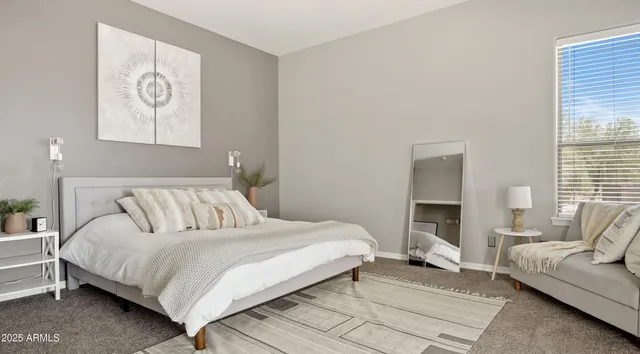 a bedroom with a bed and a couch