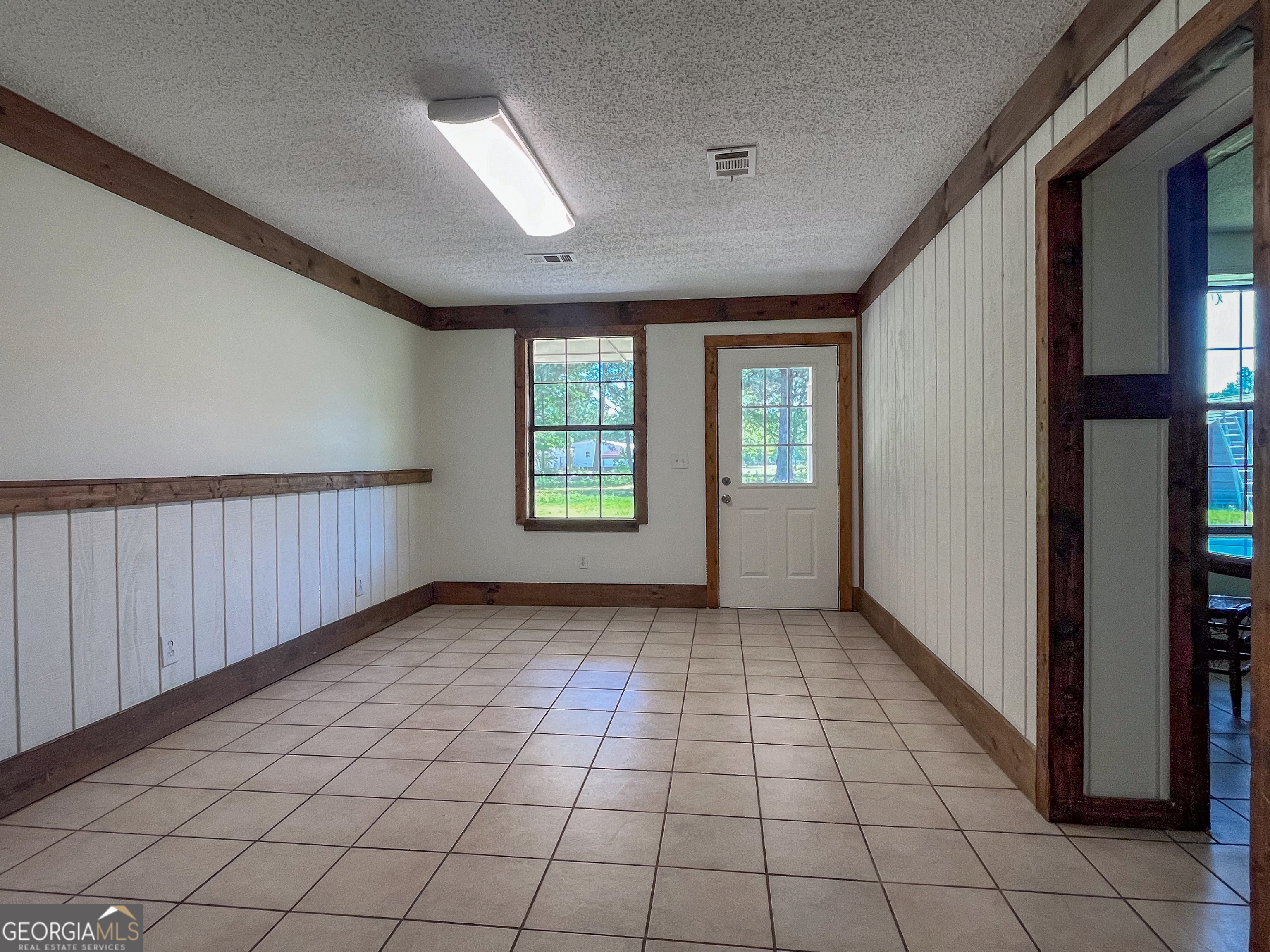 508 Denham Road East Dublin, GA 31027 - Photo 15 of 41 The back door opens to this flex space that's perfect for a home office/home school room or separate living space/dining room.