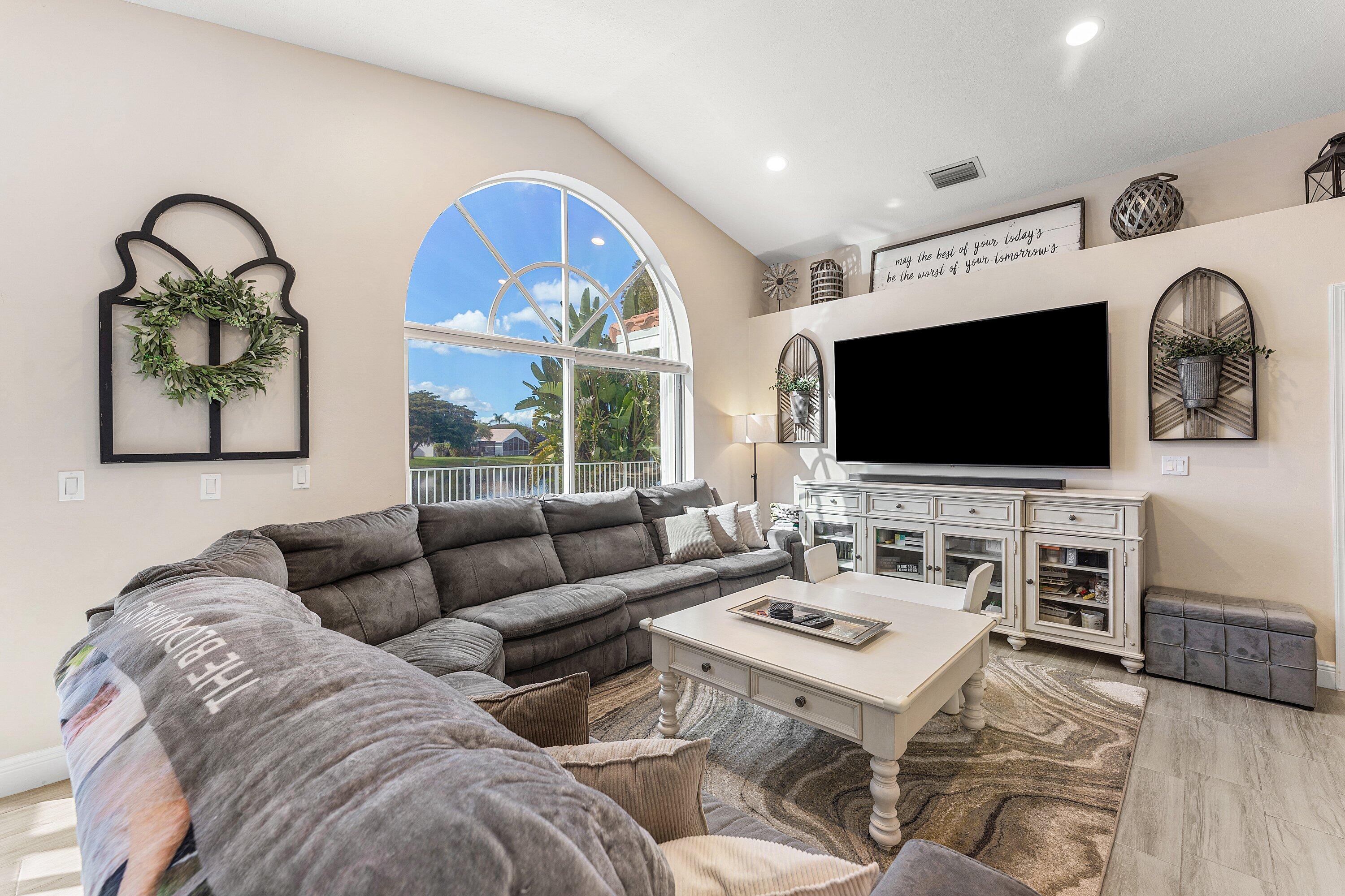 7346 Michigan Isle Road Lake Worth, FL 33467 - Photo 15 of 44 a living room with furniture and a flat screen tv