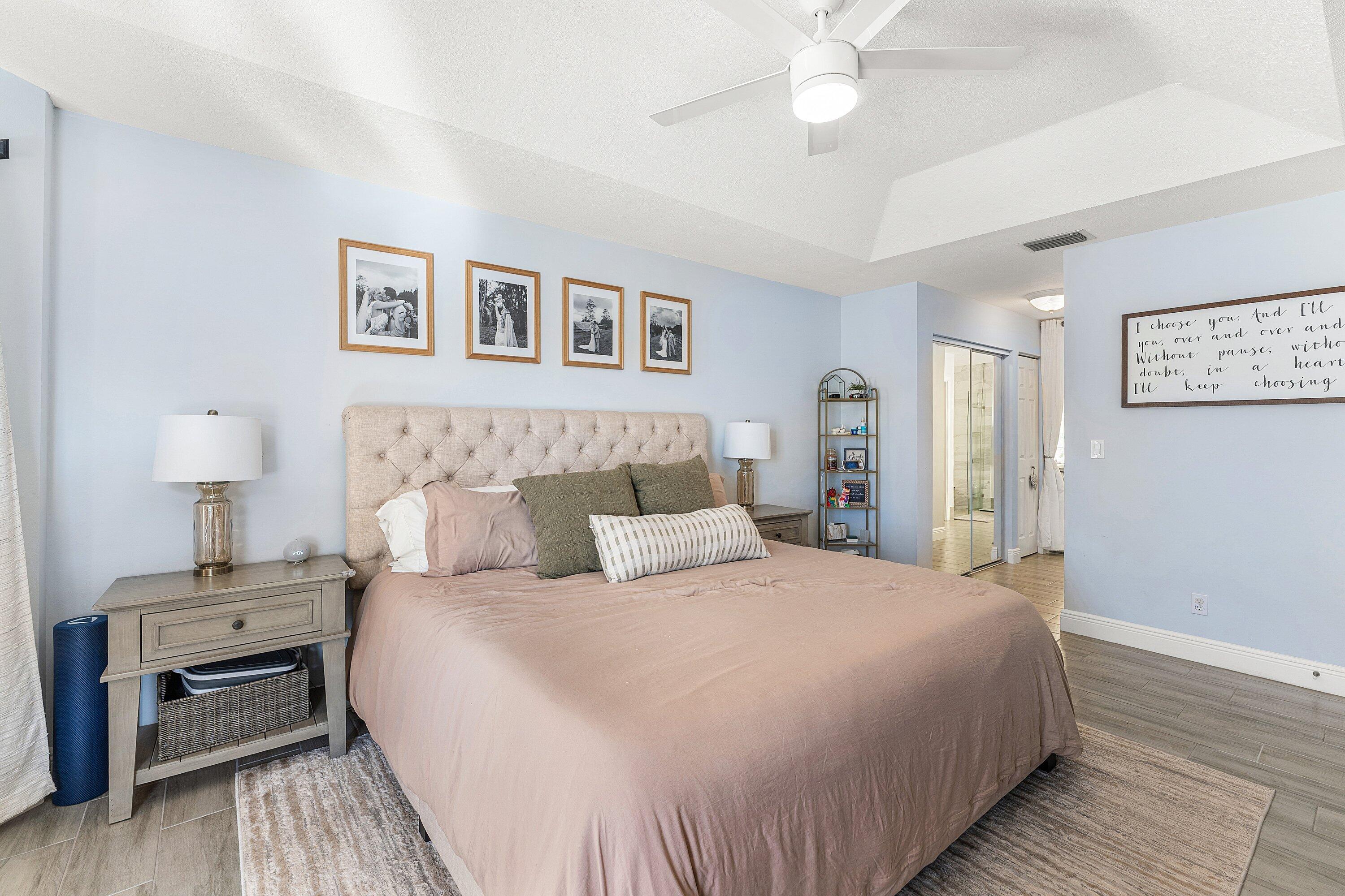 7346 Michigan Isle Road Lake Worth, FL 33467 - Photo 17 of 44 a bedroom with bed and a chandelier