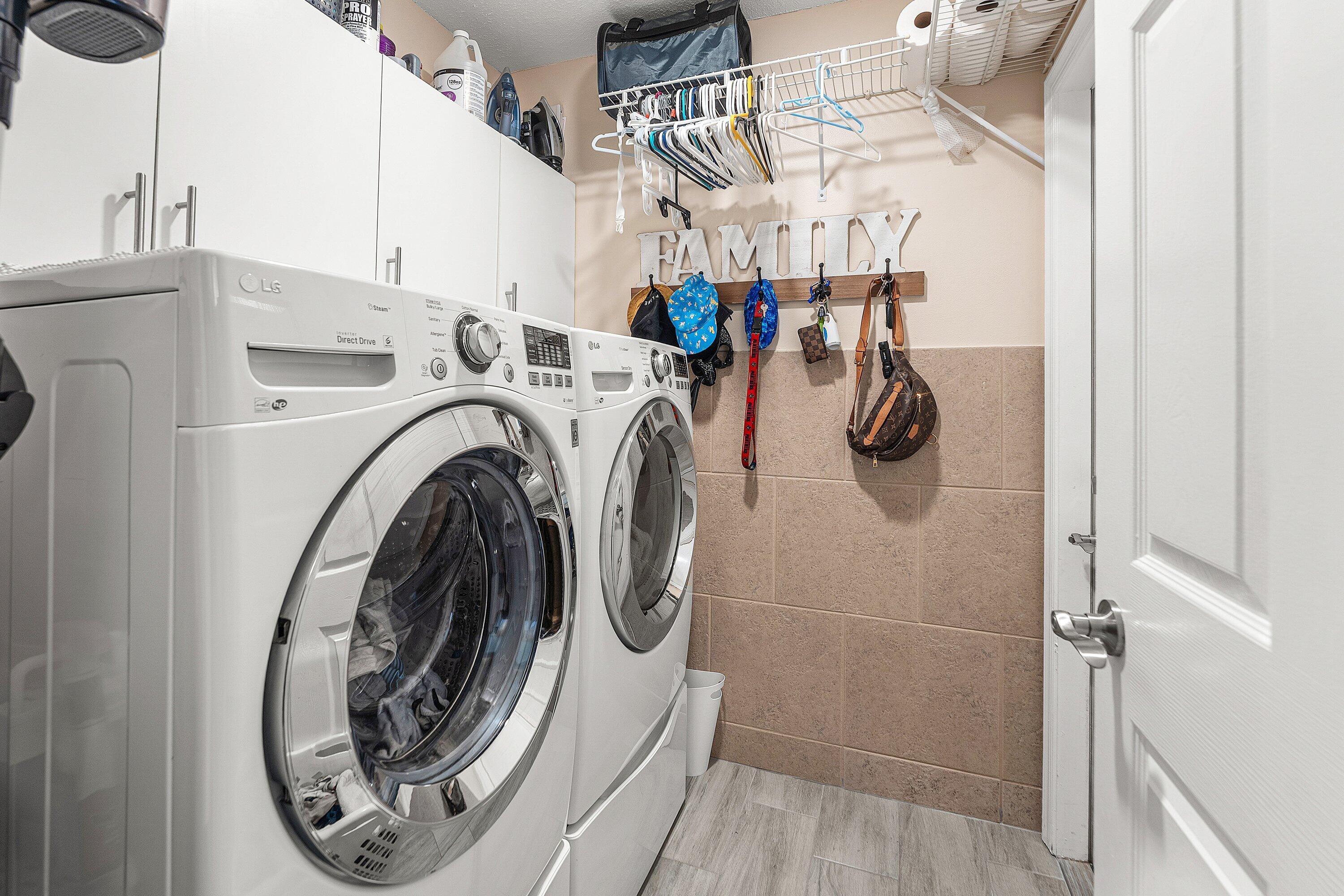 7346 Michigan Isle Road Lake Worth, FL 33467 - Photo 25 of 44 a utility room with dryer and washer