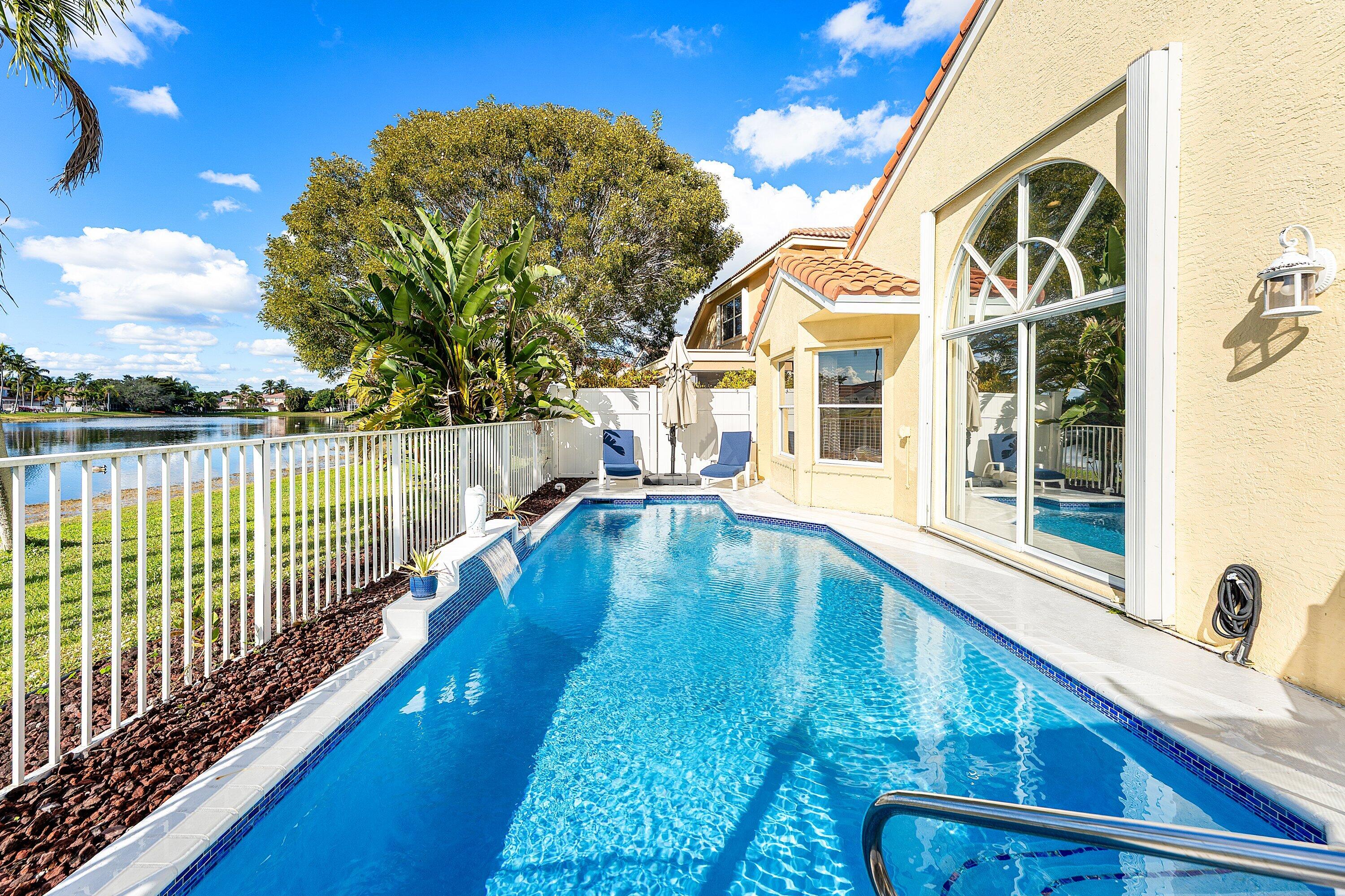 7346 Michigan Isle Road Lake Worth, FL 33467 - Photo 28 of 44 a view of a house with a swimming pool