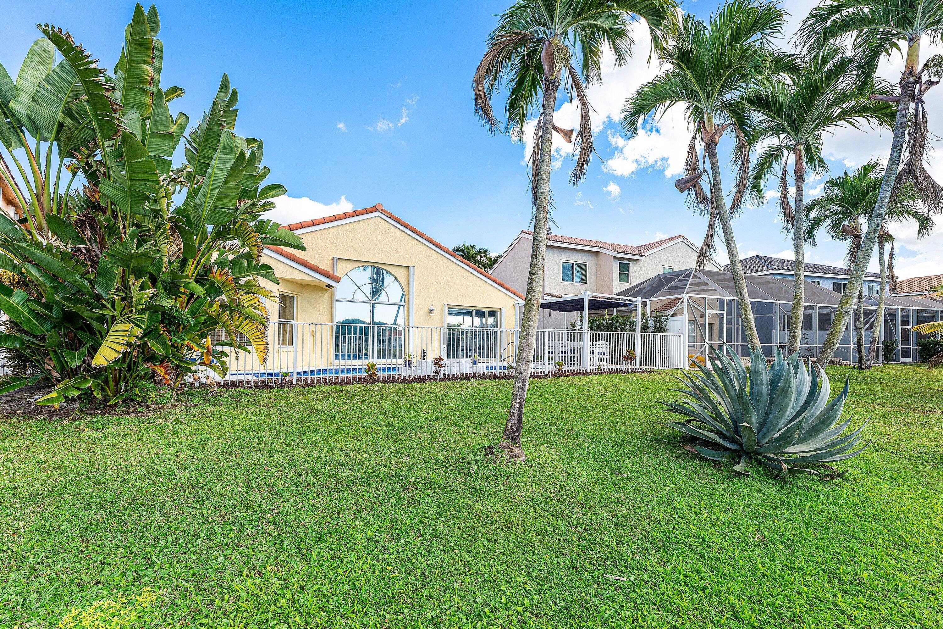 7346 Michigan Isle Road Lake Worth, FL 33467 - Photo 31 of 44 a view of a house with a backyard