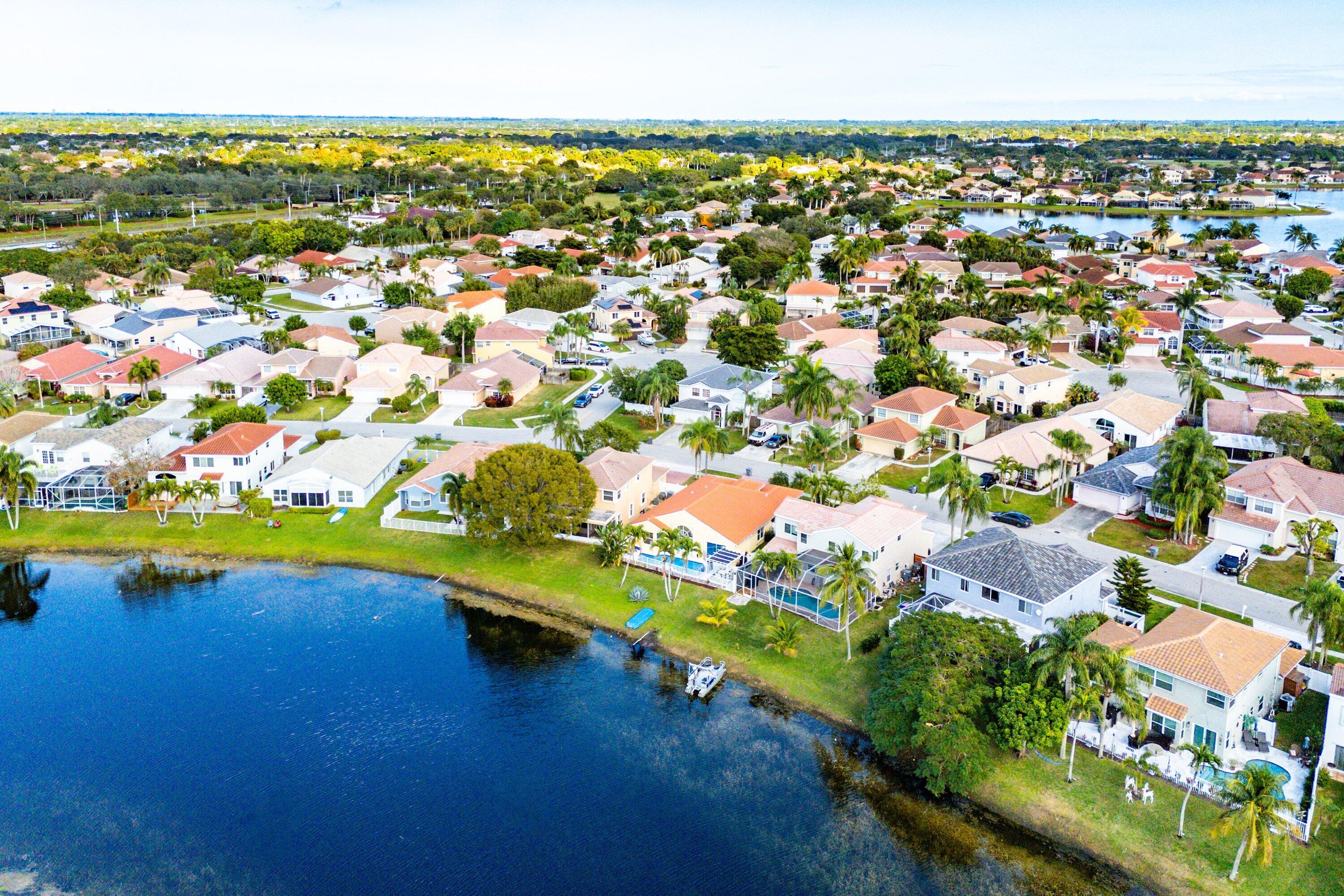 7346 Michigan Isle Road Lake Worth, FL 33467 - Photo 35 of 44 an aerial view of residential houses with outdoor space and lake view