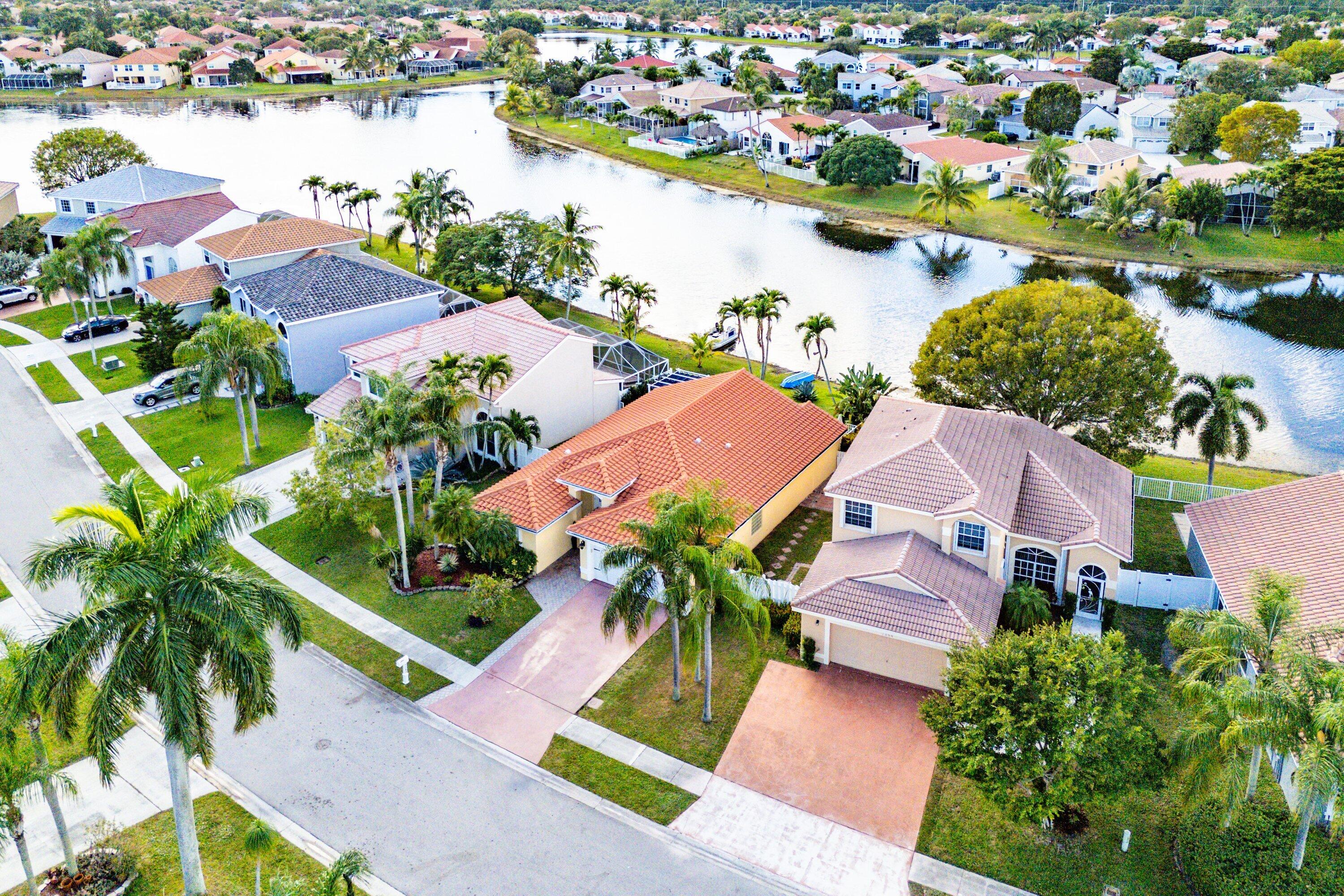 7346 Michigan Isle Road Lake Worth, FL 33467 - Photo 36 of 44 an aerial view of residential houses with outdoor space and lake view