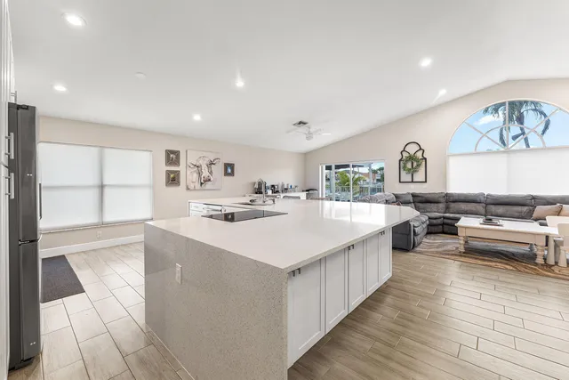 a large white kitchen with a large window