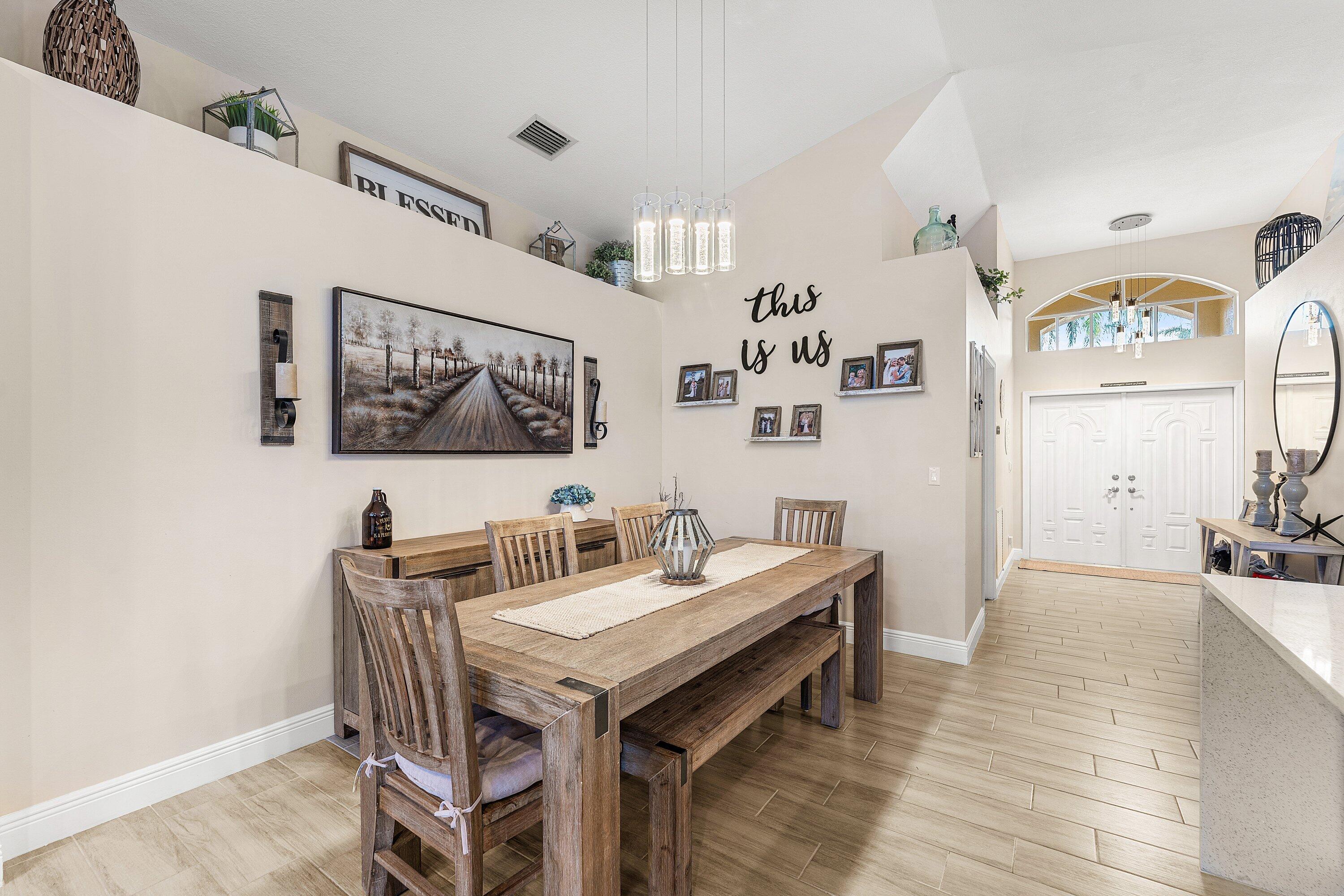 7346 Michigan Isle Road Lake Worth, FL 33467 - Photo 9 of 44 a view of a dining room with furniture
