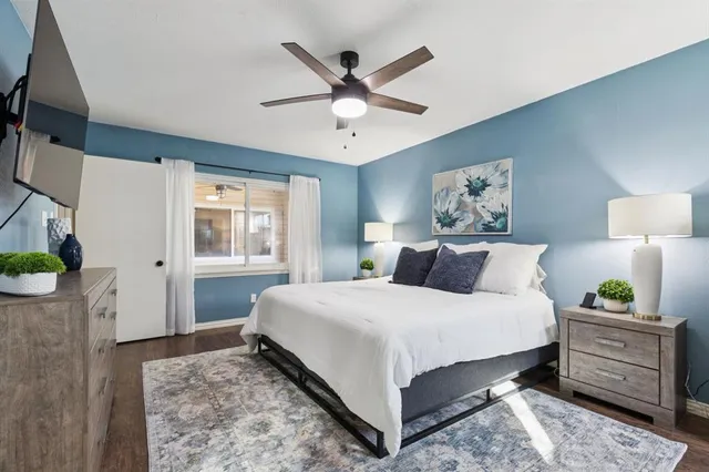 a bedroom with a bed and a flat screen tv