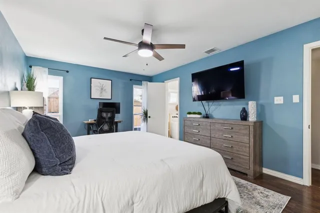 a bedroom with a large bed and flat tv