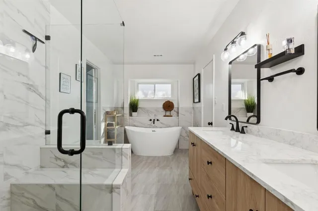 a bathroom with a double vanity sink a mirror and shower