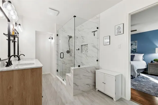 a white bath tub sitting next to a bathroom sink