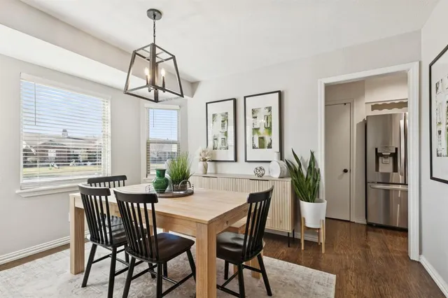 a dining room with furniture window and wooden floor