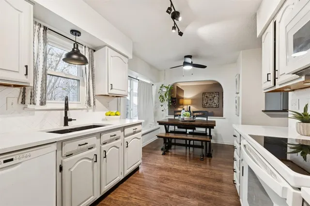 a kitchen with stainless steel appliances a sink stove and cabinets