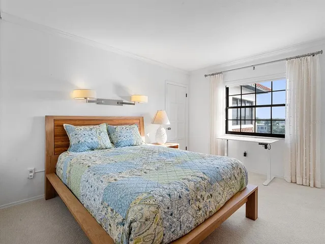 a bedroom with a large bed and a window