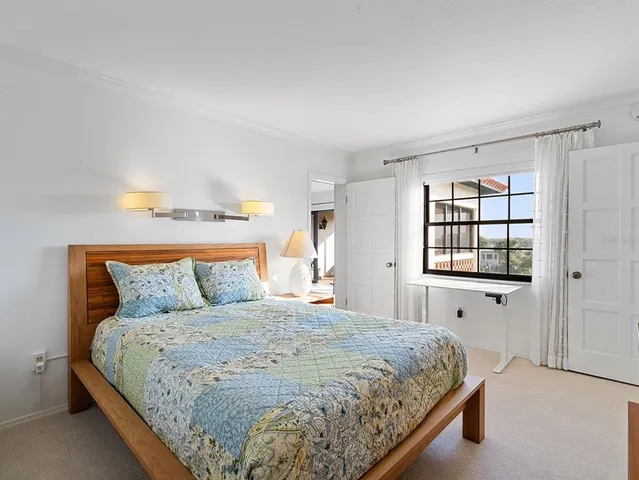 a bedroom with a bed and lamp