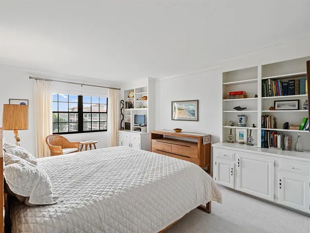 a bedroom with bed and a night stand