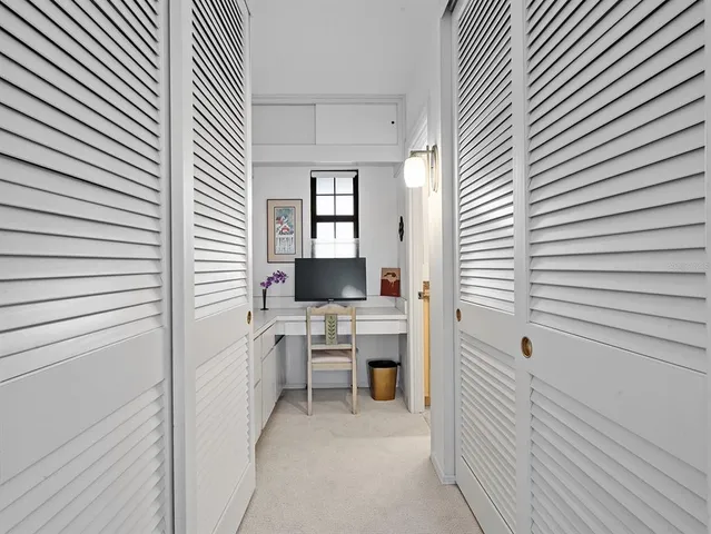 a bathroom with a granite countertop toilet sink and mirror