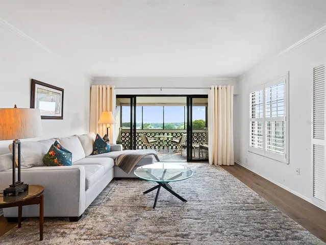 a view of a chairs and table in the balcony