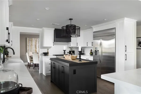 a kitchen with kitchen island a sink appliances and cabinets