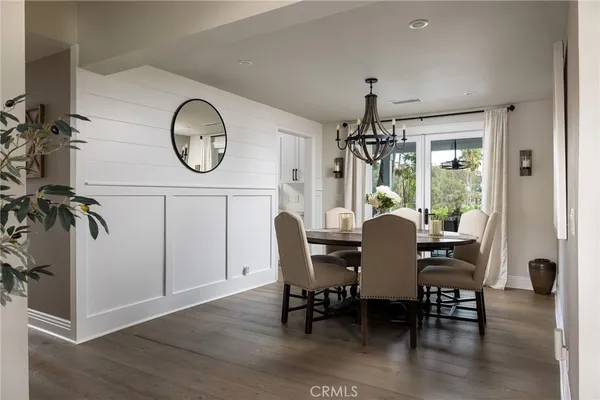 a dining room with furniture window and wooden floor