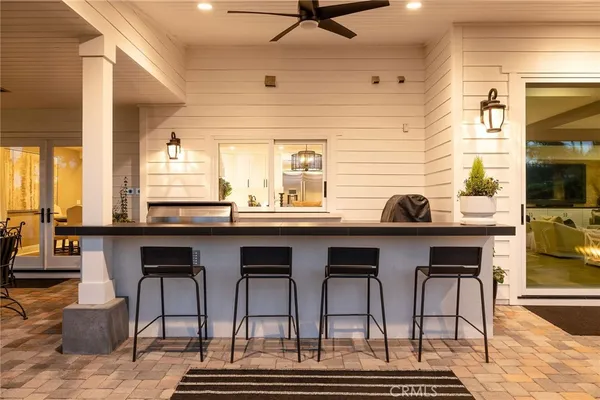 a kitchen with a sink and chairs
