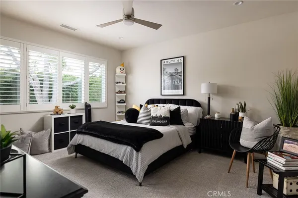 a spacious bedroom with a bed and large windows
