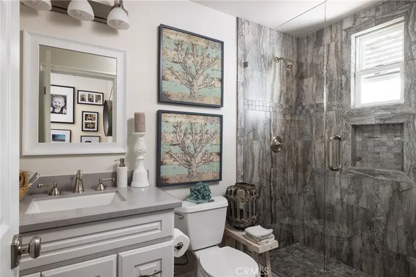 a bathroom with a sink toilet and shower