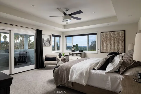 a bed room with a bed and a large window