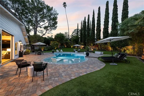 a view of a backyard with sitting area