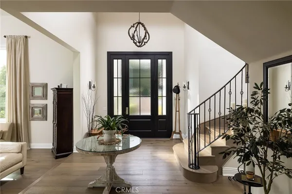 a view of entryway with wooden floor and windows