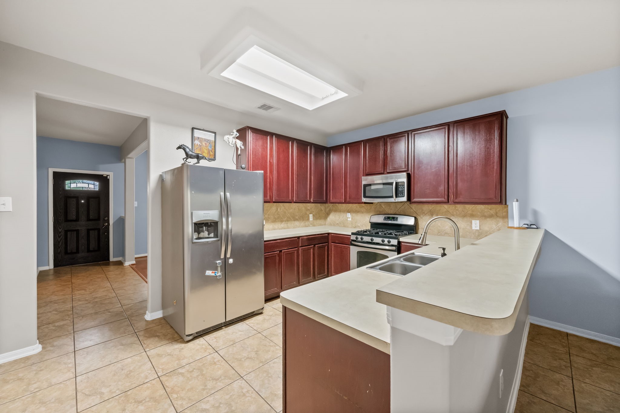 903 Northgate Springs Drive Spring, TX 77373 - Photo 6 of 36 a kitchen with stainless steel appliances granite countertop a refrigerator stove and sink
