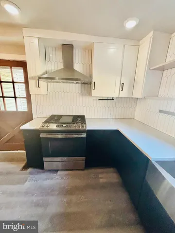 a stove top oven sitting inside of a kitchen
