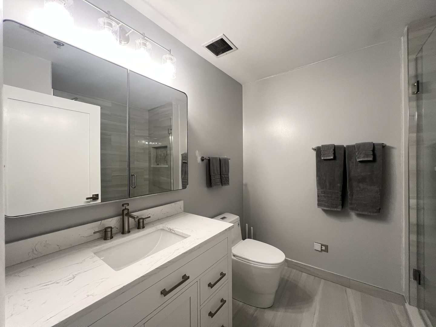 910 West Madison Street, Unit 602 Chicago, IL 60607 - Photo 11 of 13 a bathroom with a toilet sink and mirror