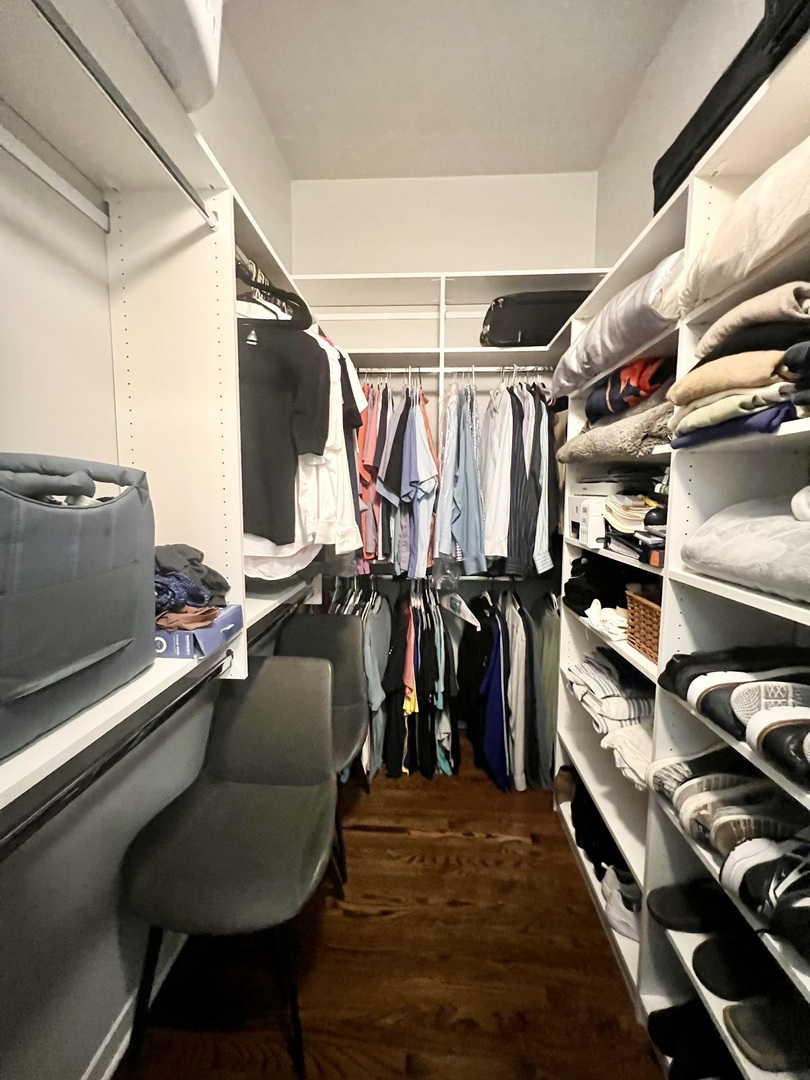 910 West Madison Street, Unit 602 Chicago, IL 60607 - Photo 7 of 13 a view of walk in closet with clothes and shoes