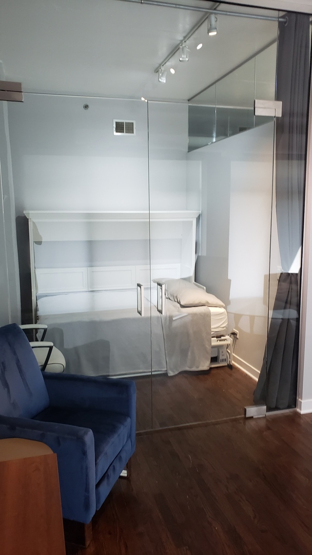 910 West Madison Street, Unit 602 Chicago, IL 60607 - Photo 8 of 13 a bedroom with a bed and walk in closet