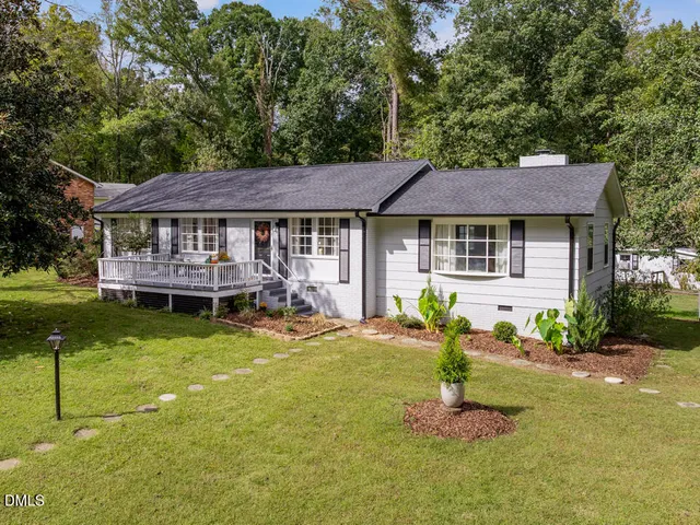 a house view with swimming pool and garden space