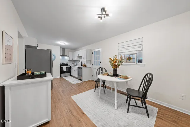 a living room with furniture a dining table and a flat screen tv