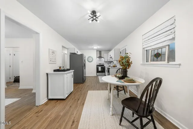 a view of a dining room with furniture and wooden floor