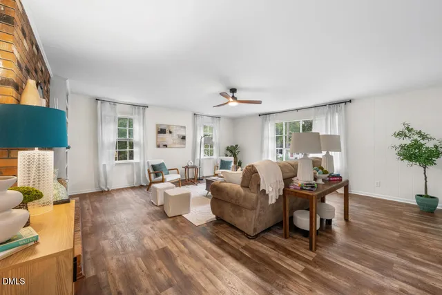 a living room with furniture and wooden floor
