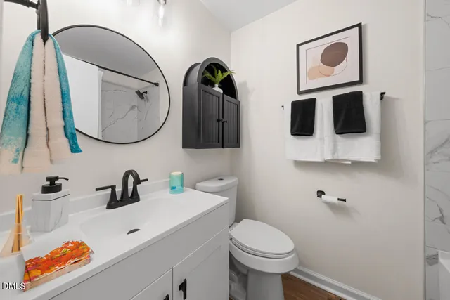 a bathroom with a sink a mirror and toilet
